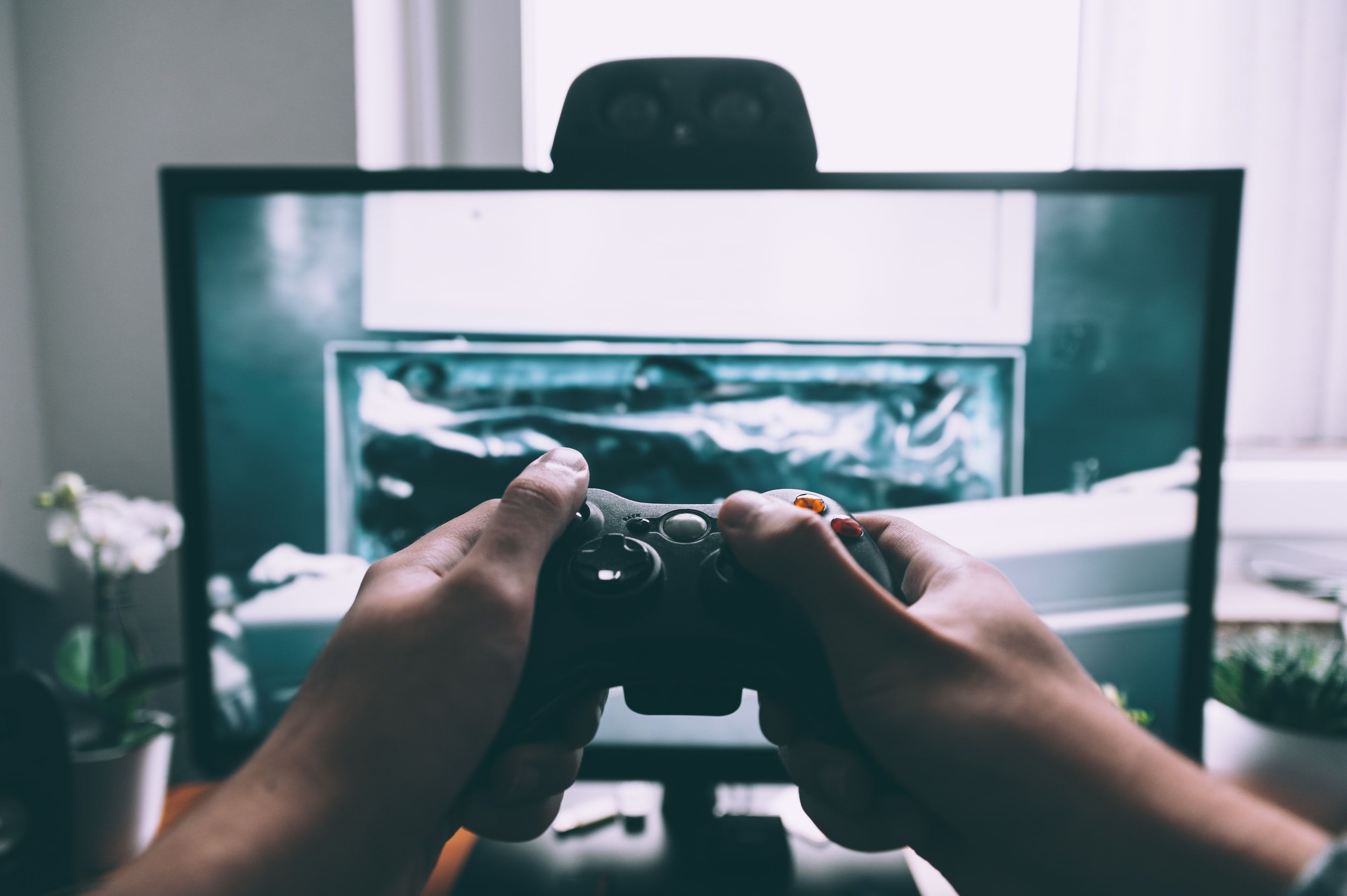 https://unsplash.com/photos/person-holding-game-controller-in-front-of-television-0woyPEJQ7jc